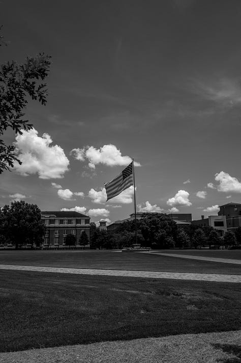 Mississippi State football stadium, campus with American flag, cowbell