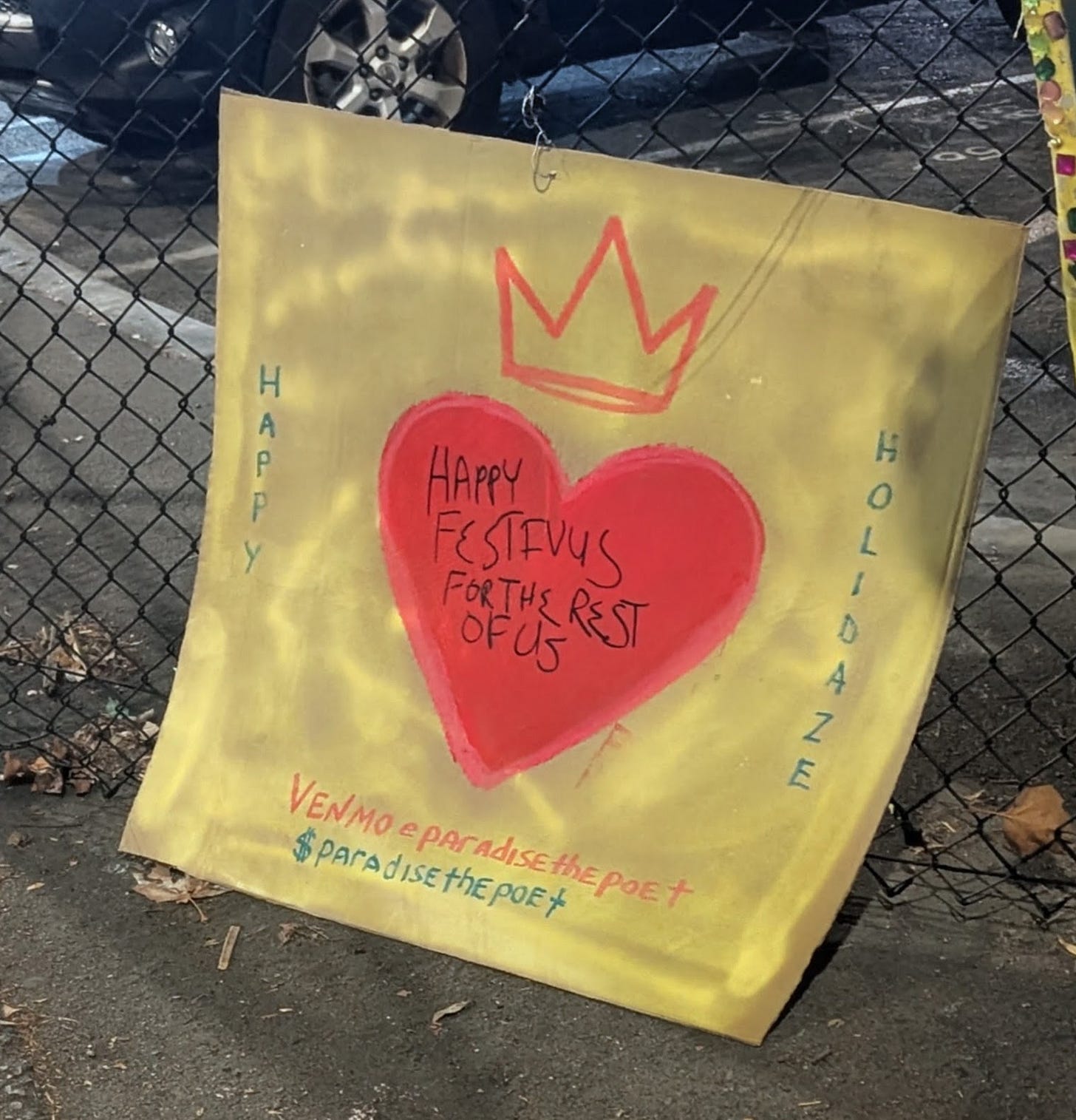 A handmade sign featuring a red heart and the inscription "Happy Festivus for the rest of us"