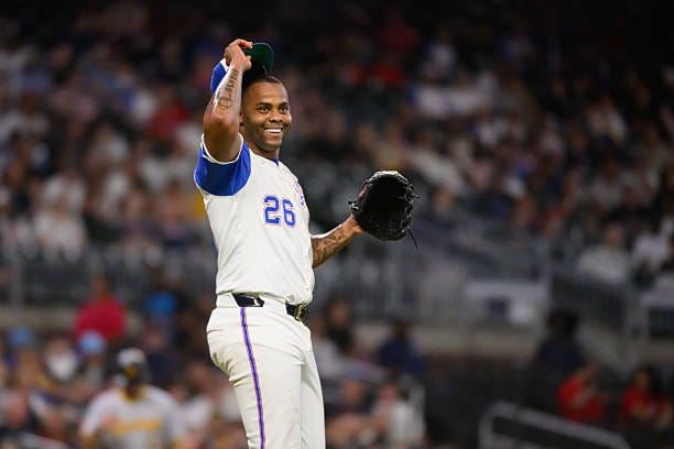 Raisel Iglesias of the Atlanta Braves smiles in disbelief after a call in the ninth inning of a game against the Pittsburgh Pirates at Truist Park on...