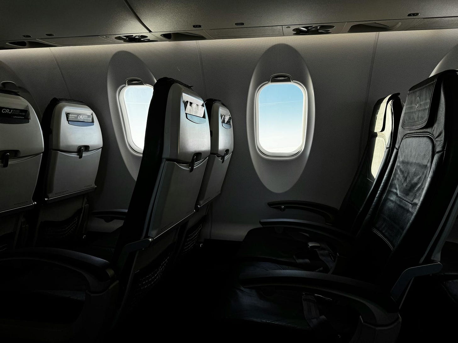 Empty seatback pocket on a regional jet with only a safety card inside Empty seatback pocket on a regional jet with only a safety card inside