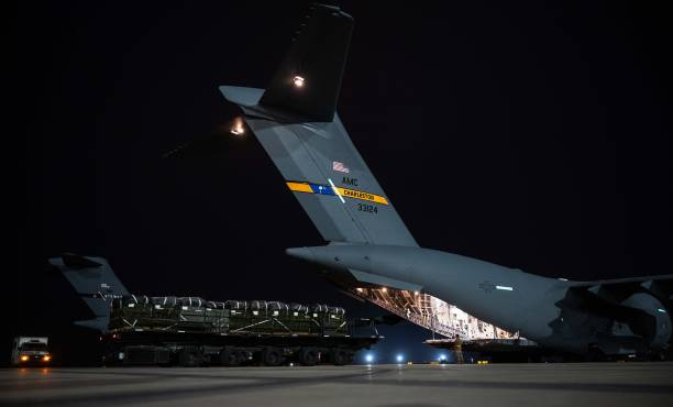 Central Command soldiers load humanitarian aid packages into a C-17 Globemaster III of US Air Force, to be airdropped into Gaza, in Tampa, Florida,...