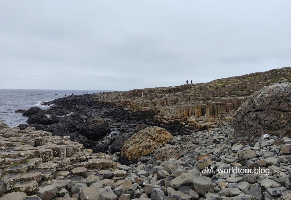 Basalt columns of varying heights make up the Giant's Causeway in Northern Ireland. Colours vary from grey, to black and beige.