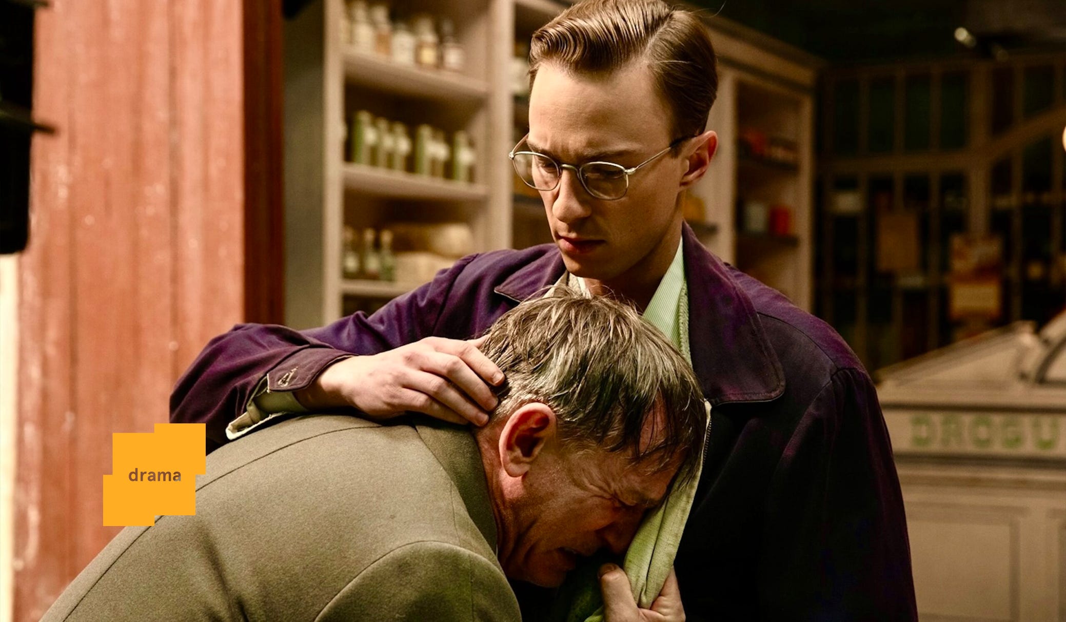 Drew Starkey as Eugene embraces a crying Daniel Craig as Lee in Queer