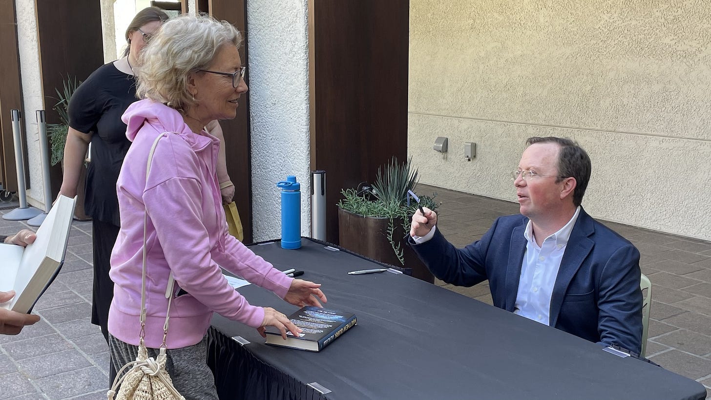 Local author Matthew Quirk, right, speaks with a fan on Saturday at the Dove Library in Carlsbad after a book event discussing his latest novel, “The Method,” and his 2019 novel and Netflix smash hit, “The Night Agent.” Local author Matthew Quirk, right, speaks with a fan on Saturday at the Dove Library in Carlsbad after a book event discussing his latest novel, “The Method,” and his 2019 novel and Netflix smash hit, “The Night Agent.”