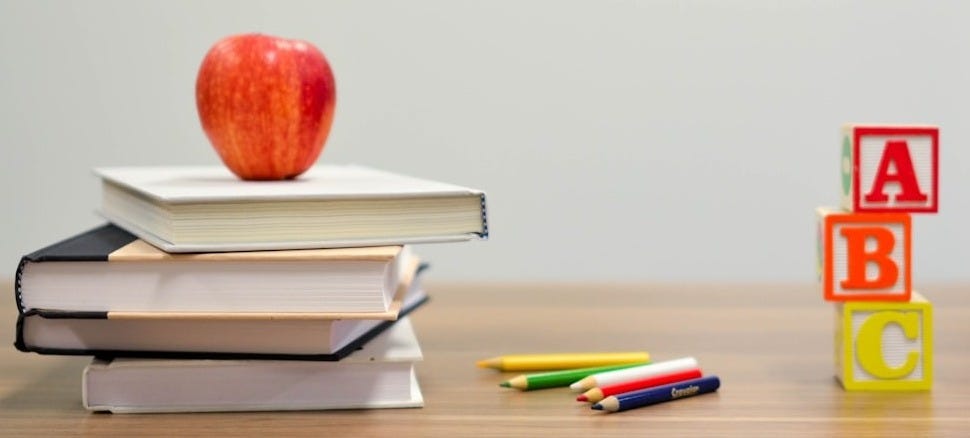 red apple fruit on four pyle books red apple fruit on four pyle books