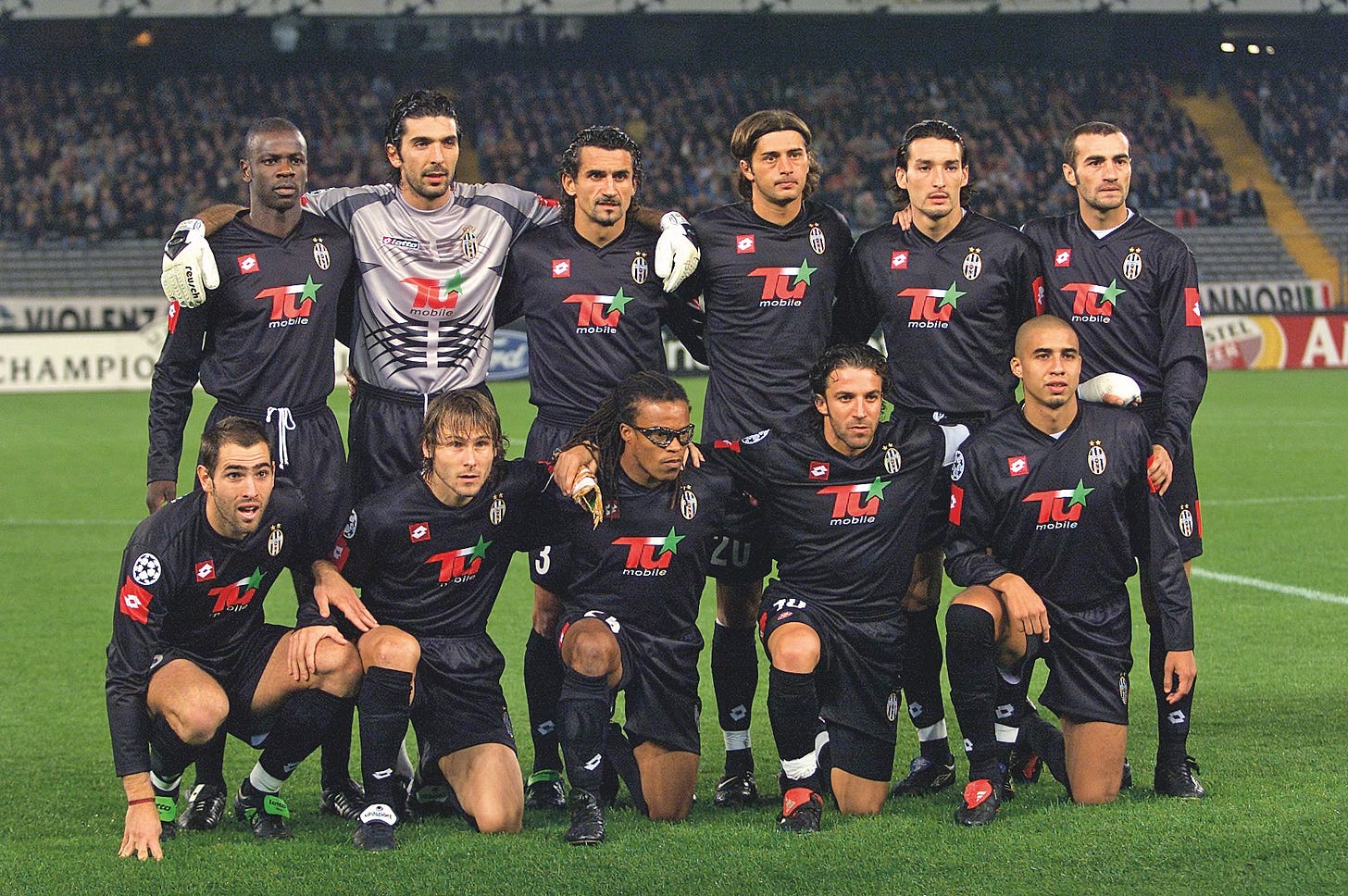 Juventus starting lineup poses in black Tamoil-sponsored kits before a Champions League match, early 2000s.