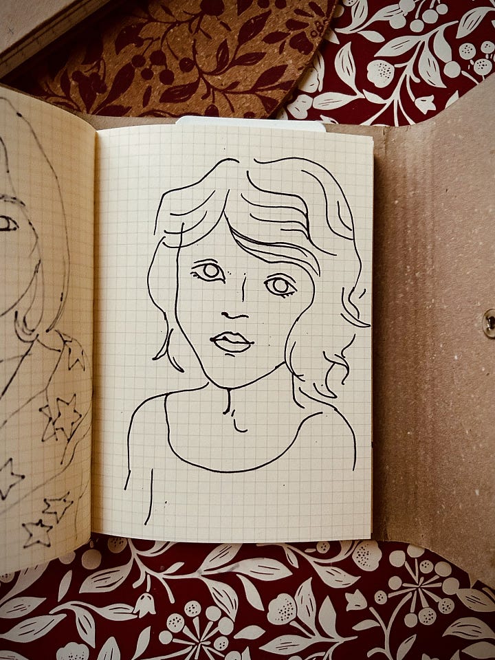 A loose marker landscape with blues and greens, two line portraits of my daughters, a realistic drawing of a feather with a real feather on top