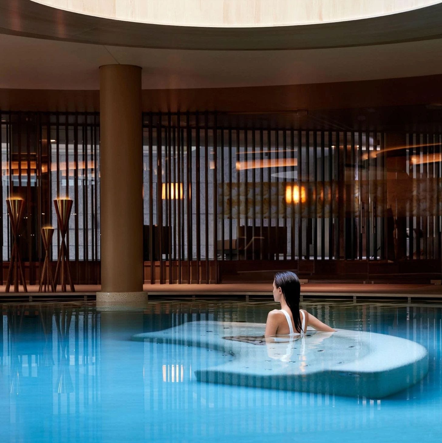 Guest relaxing in an indoor pool at Lefay Resort & SPA