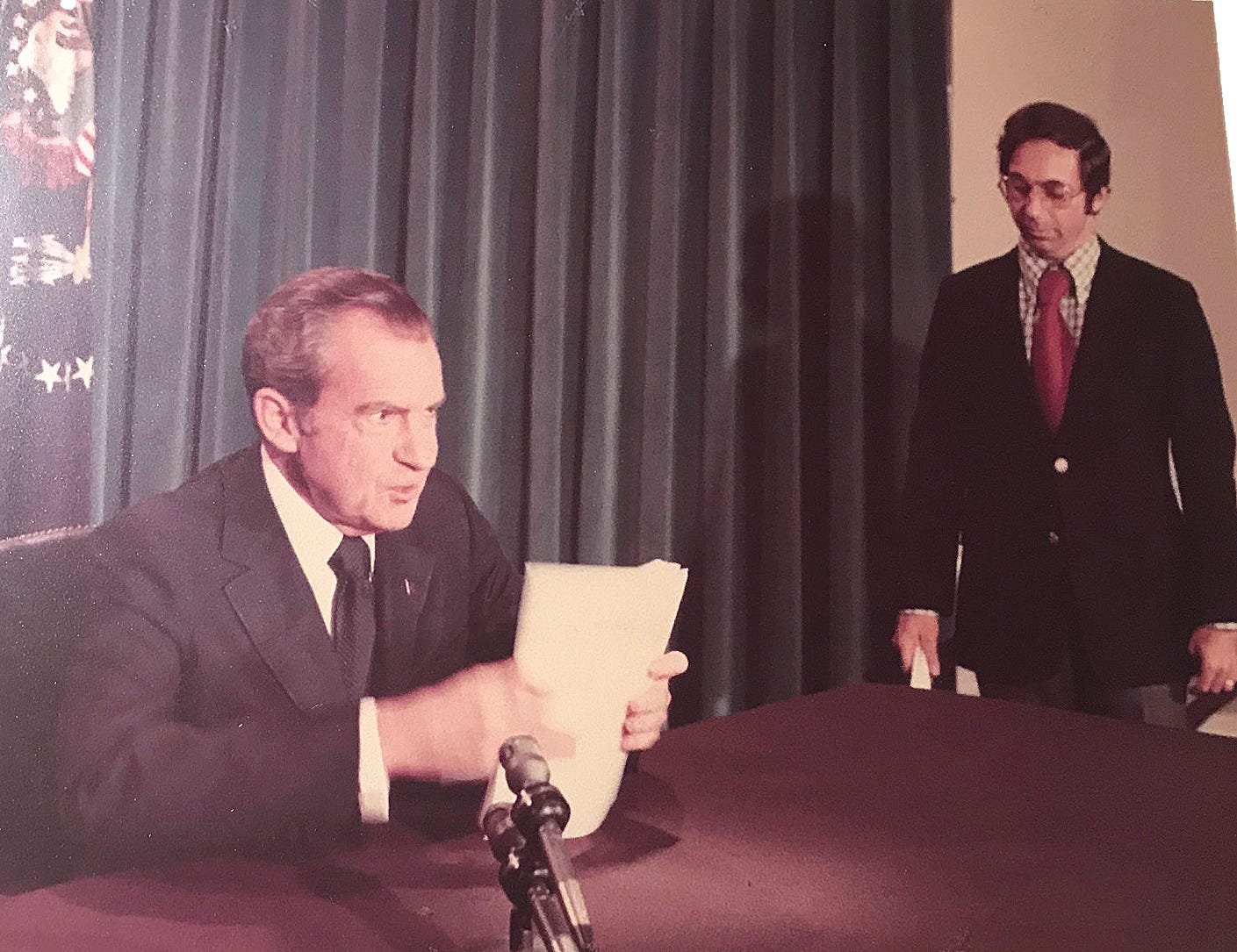 richard nixon at desk reading resignation speech, three quarter profile; off to side is a male aide richard nixon at desk reading resignation speech, three quarter profile; off to side is a male aide