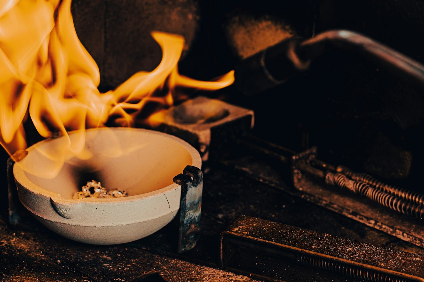 a bowl of food on a stove with flames coming out of it