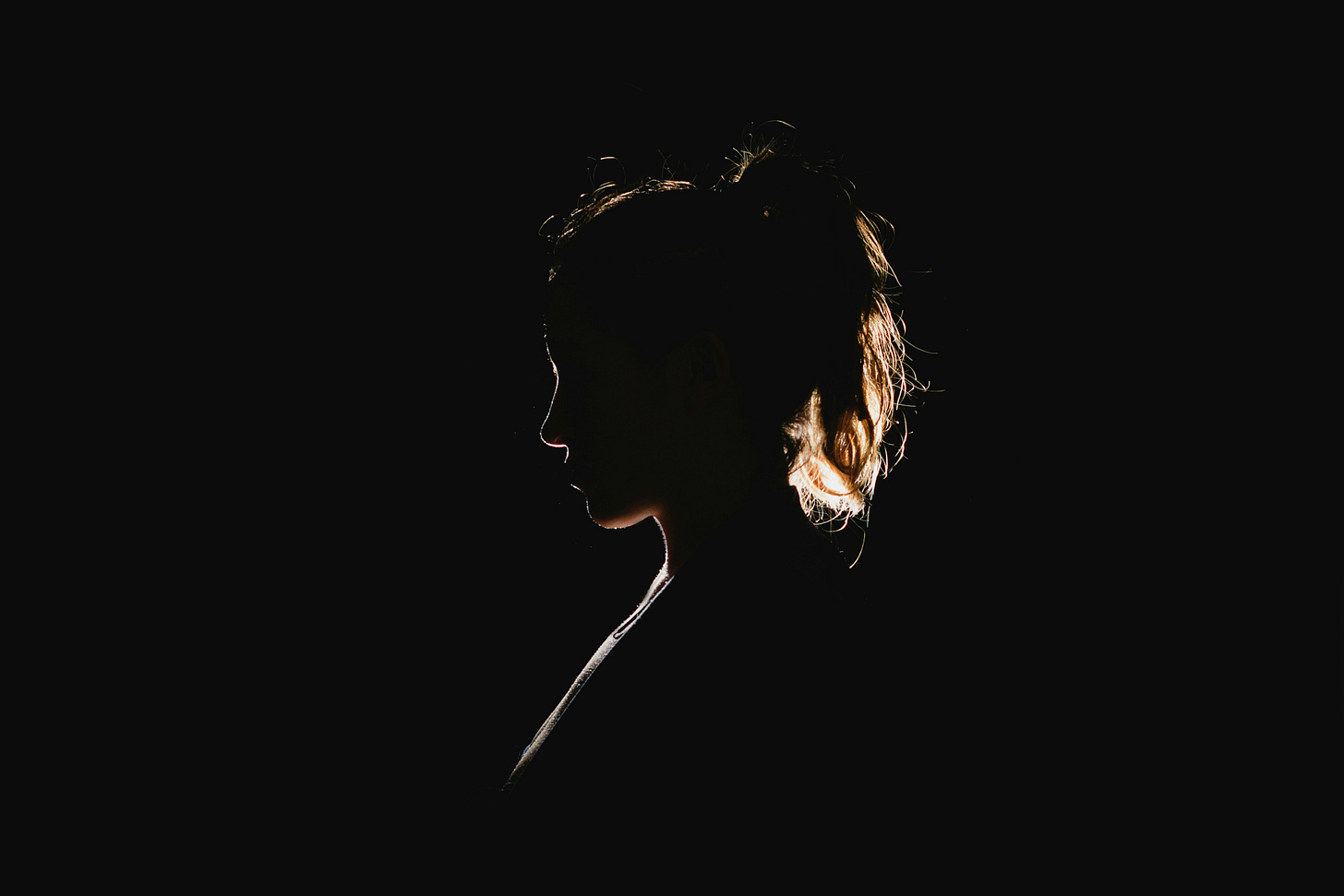 A woman's silohuette on a black background. 