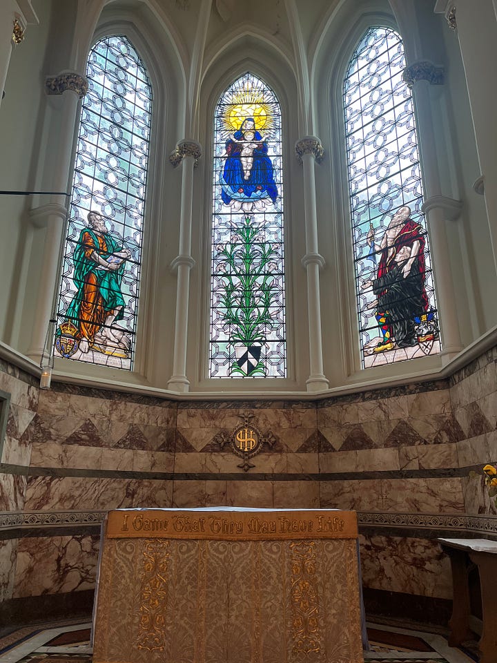 Stained glass and exterior architectural details of the church of St Bartholomew the Less at Barts.