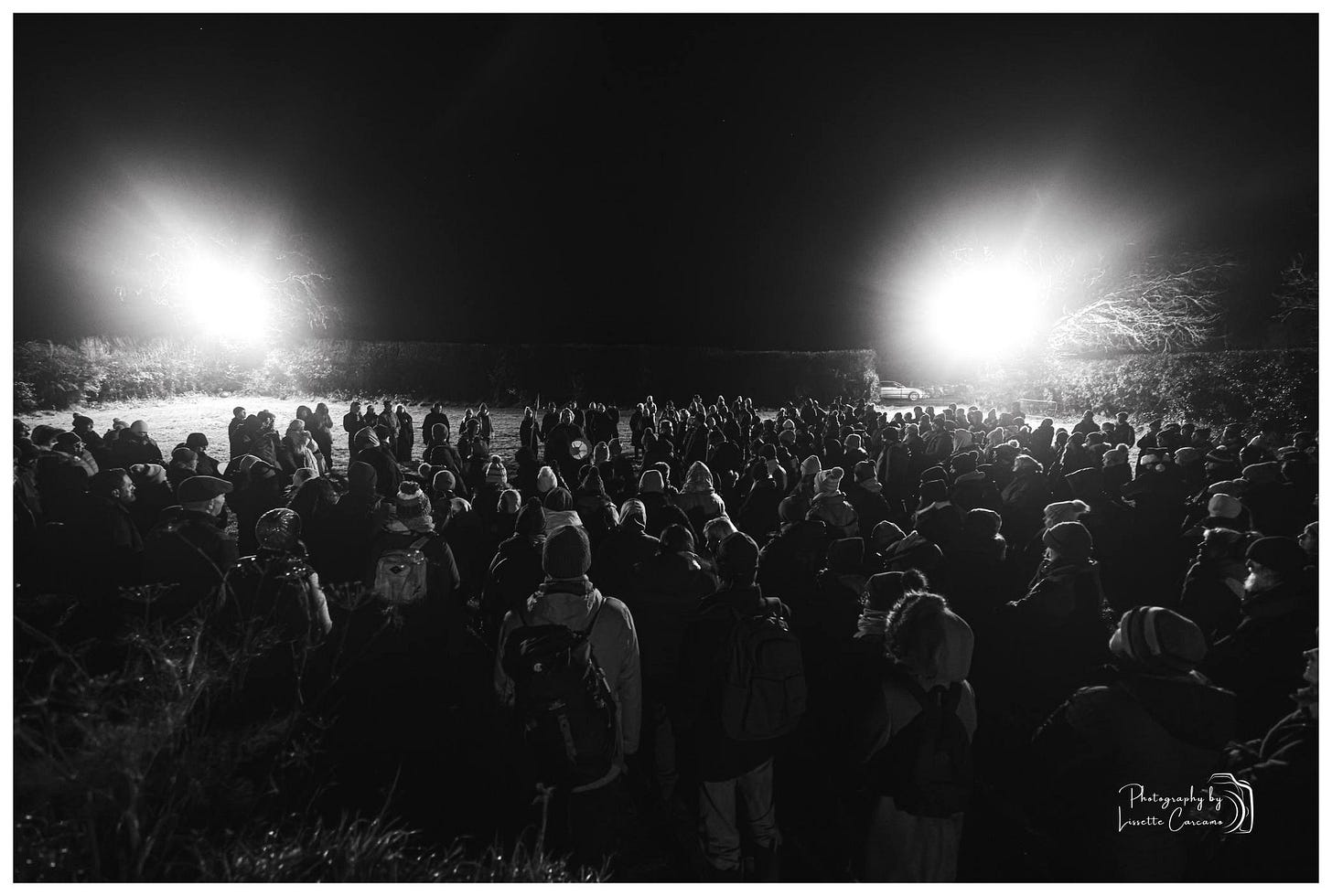 May be a black-and-white image of one or more people, lighting, crowd and text