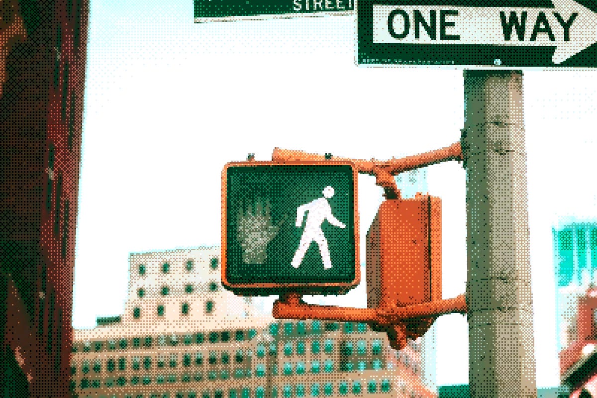 Pedestrian traffic light, with a One Way sign above it Pedestrian traffic light, with a One Way sign above it