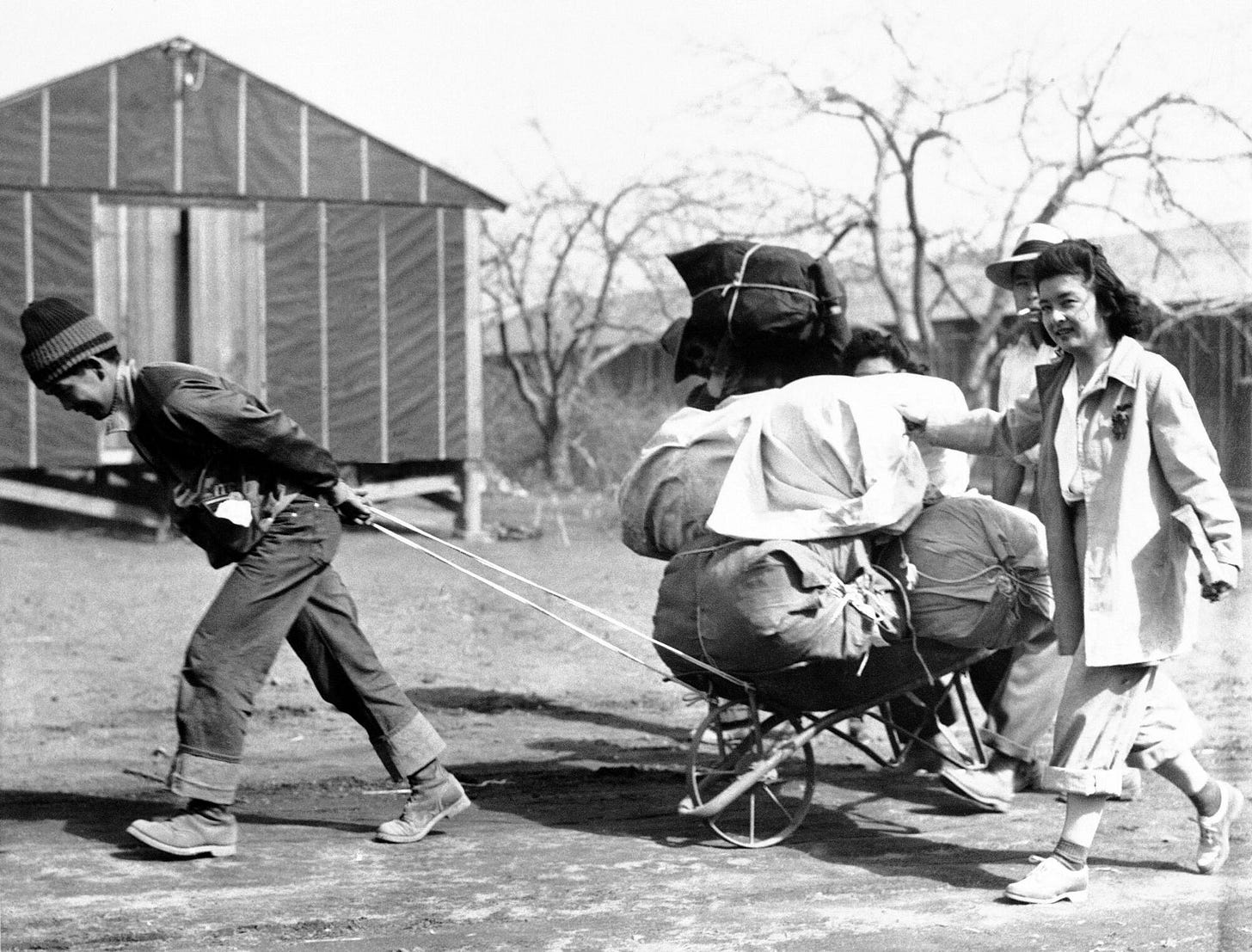 People drag bundles of belongings