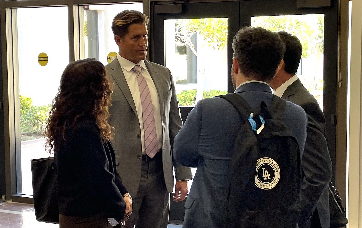 Encinitas City Councilman Luke Shaffer, second from left, speaks with his legal team after Wednesday’s hearing. The hearing saw a judge order the release of a security video showing the incident between Shaffer and another man, leading to a felony charge, which Shaffer’s attorney strongly denied. Steve Puterski photo