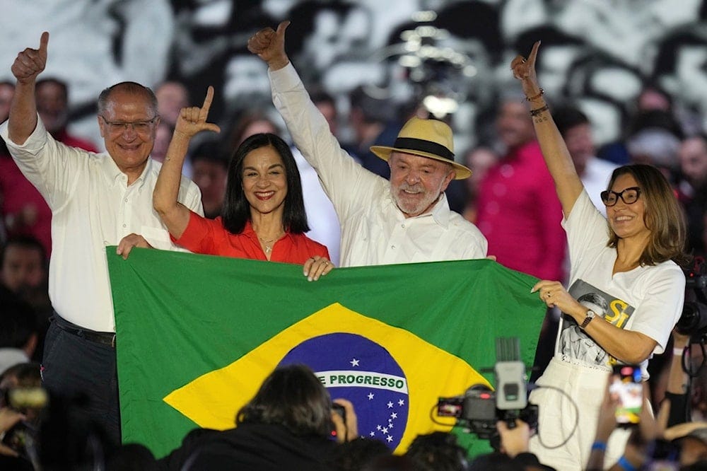 Brazilian President Luiz Inacio Lula da Silva, Vice President Geraldo Alckmin, Brazil's first lady Rosangela da Silva, and Vice-President's wife Lu Alckmin hold a Brazilian flag during the Workers' Party convention, where Lula was confirmed Brazilian President Luiz Inacio Lula da Silva, Vice President Geraldo Alckmin, Brazil's first lady Rosangela da Silva, and Vice-President's wife Lu Alckmin hold a Brazilian flag during the Workers' Party convention, where Lula was confirmed