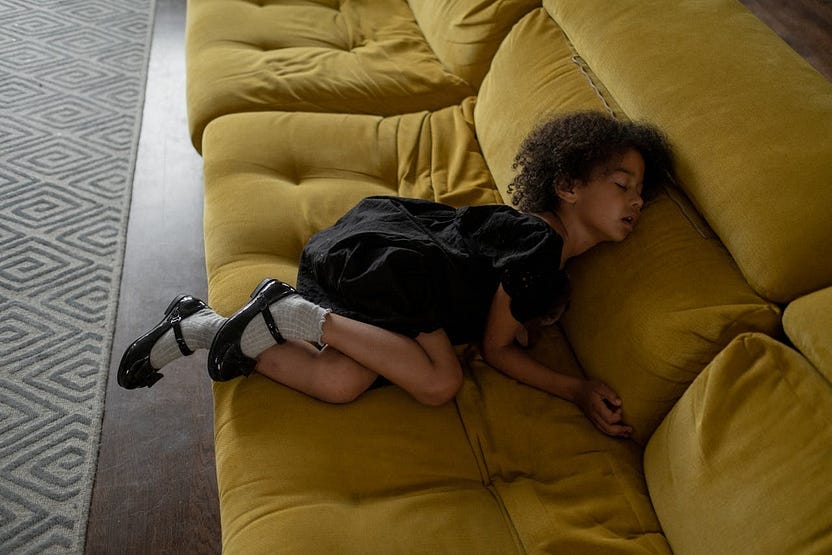 Image of a girl fast asleep on the sofa