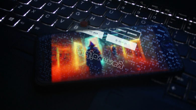 A keyboard with a phone on it showing Midjourney.