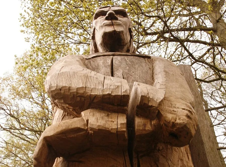 figure of a man carved in wood