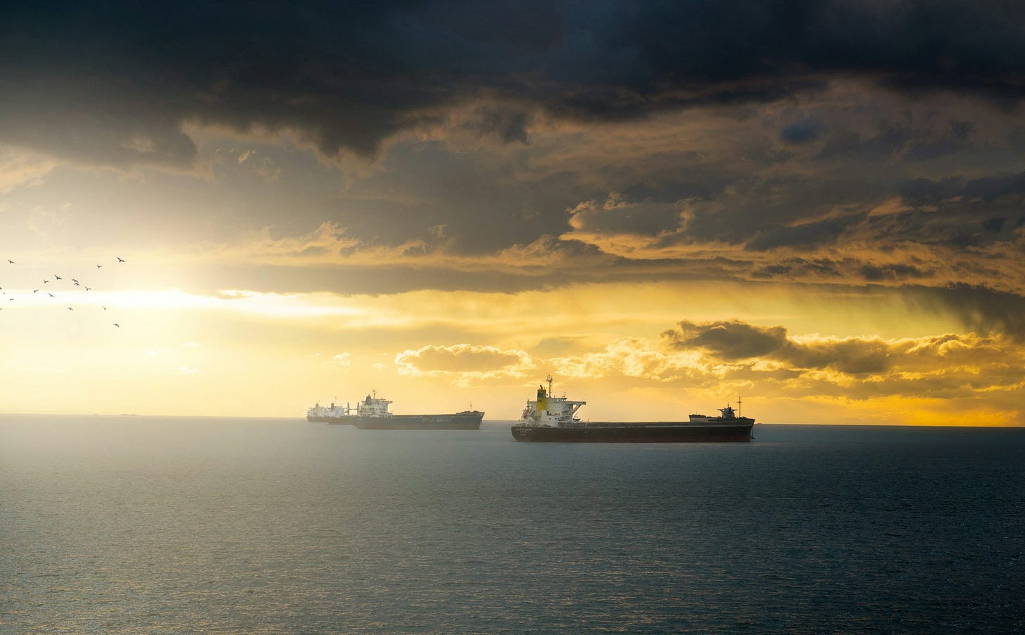 a group of ships floating on top of a large body of water