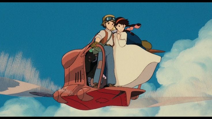This may contain: a man and woman riding on the back of a red car in front of a blue sky