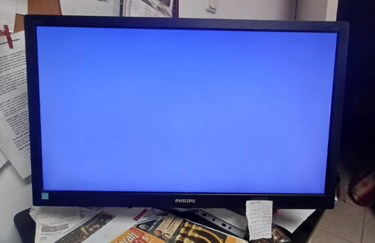 Blank computer monitor on messy desk