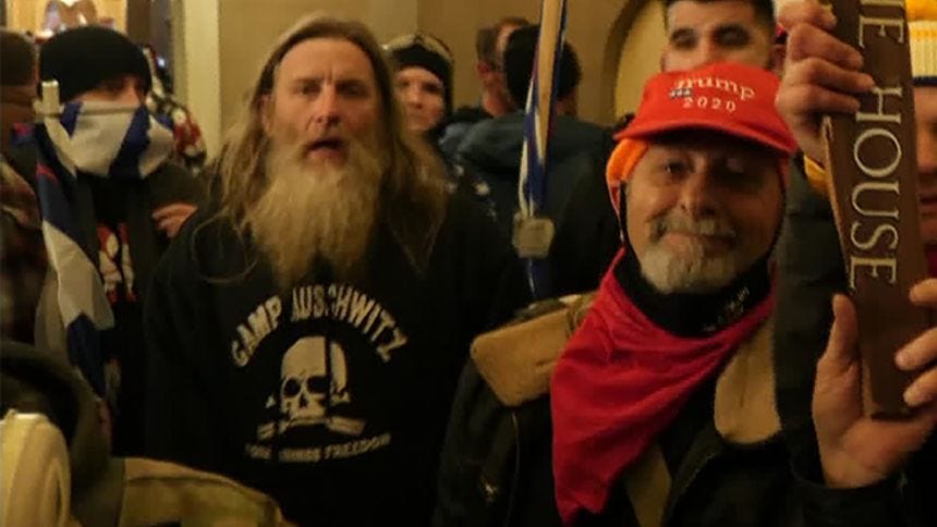 Robert Keith Packer, left, was seen at the Capitol Hill riot and insurrection wearing a sweatshirt with the words, "Camp Auschwitz."