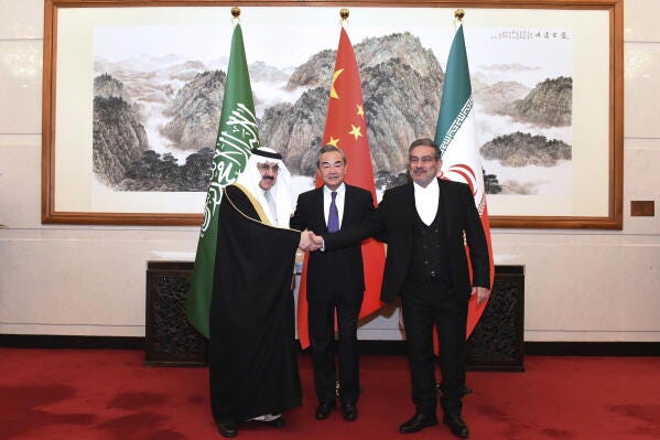 In this photo released by Xinhua News Agency, Ali Shamkhani, the secretary of Iran's Supreme National Security Council, at right, shakes hands with Saudi national security adviser Musaad bin Mohammed al-Aiban, at left, as Wang Yi, China's most senior diplomat, looks on, at center, for a photo during a closed meeting held in Beijing, Saturday, March 11, 2023. Iran and Saudi Arabia agreed Friday to reestablish diplomatic relations and reopen embassies after seven years of tensions. The major diplomatic breakthrough negotiated with China lowers the chance of armed conflict between the Mideast rivals, both directly and in proxy conflicts around the region. (Luo Xiaoguang/Xinhua via AP) In this photo released by Xinhua News Agency, Ali Shamkhani, the secretary of Iran's Supreme National Security Council, at right, shakes hands with Saudi national security adviser Musaad bin Mohammed al-Aiban, at left, as Wang Yi, China's most senior diplomat, looks on, at center, for a photo during a closed meeting held in Beijing, Saturday, March 11, 2023. Iran and Saudi Arabia agreed Friday to reestablish diplomatic relations and reopen embassies after seven years of tensions. The major diplomatic breakthrough negotiated with China lowers the chance of armed conflict between the Mideast rivals, both directly and in proxy conflicts around the region. (Luo Xiaoguang/Xinhua via AP)