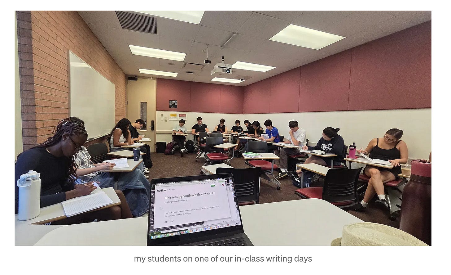 students sitting in a classroom writing on paper and a text caption that says "my students on one of our in-class writing days" students sitting in a classroom writing on paper and a text caption that says "my students on one of our in-class writing days"