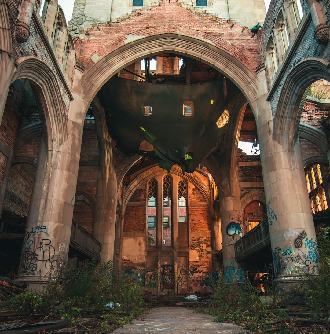 an abandoned building with graffiti on the floor