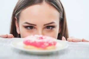 Pretty young woman wants to eat sweet food