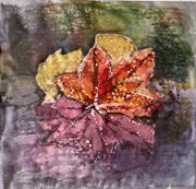 A batik print on silk of a leaf floating on water, reflected into multiple different colours. It has droplets of water all over it.