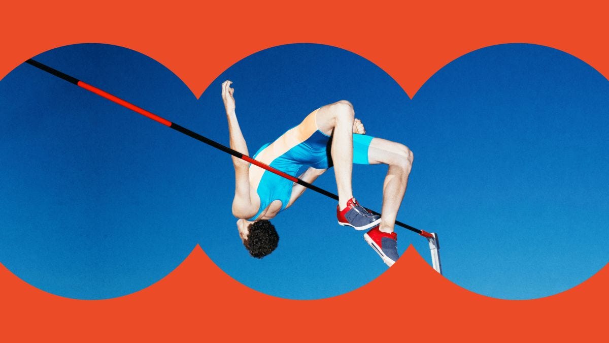 An athlete in blue sportswear and red shoes performs a high jump against a clear blue sky, framed by a red, scalloped border.