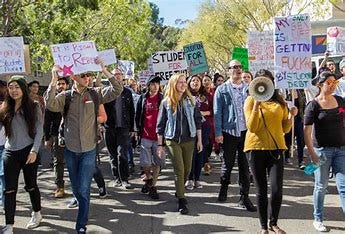 Image result for generate a picture of a group of angry college students protesting afgainst apple pie