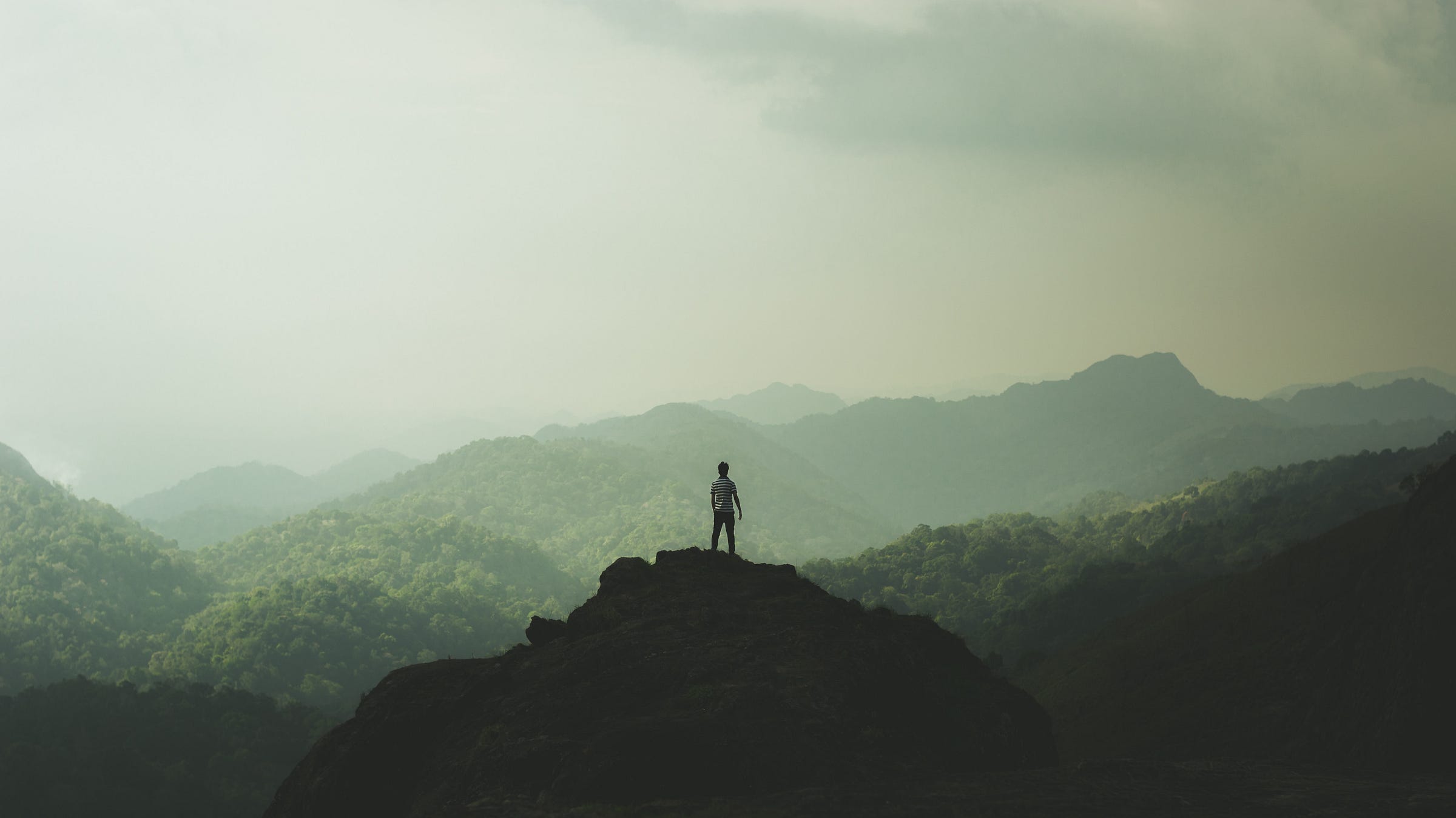 A man standing on a mountaintop A man standing on a mountaintop