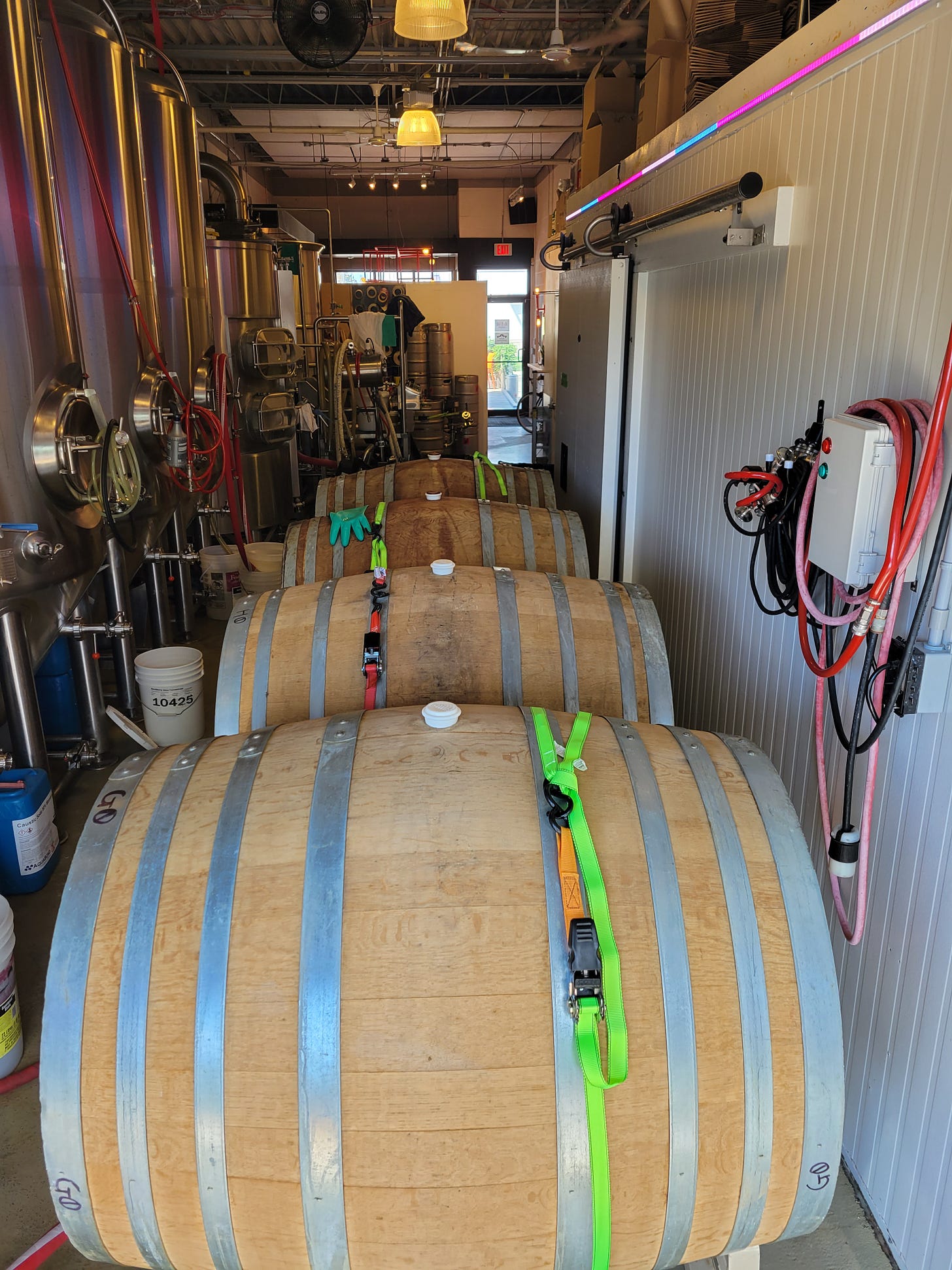 Four huge barrels squeezed into a narrow, brightly lit brewery