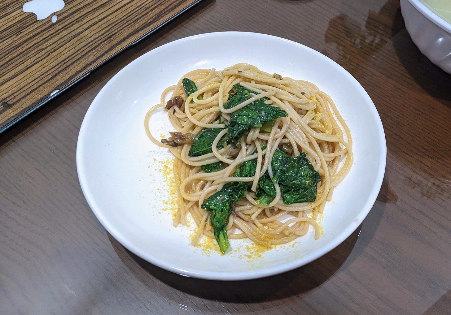 spaghetti with greens on a plate