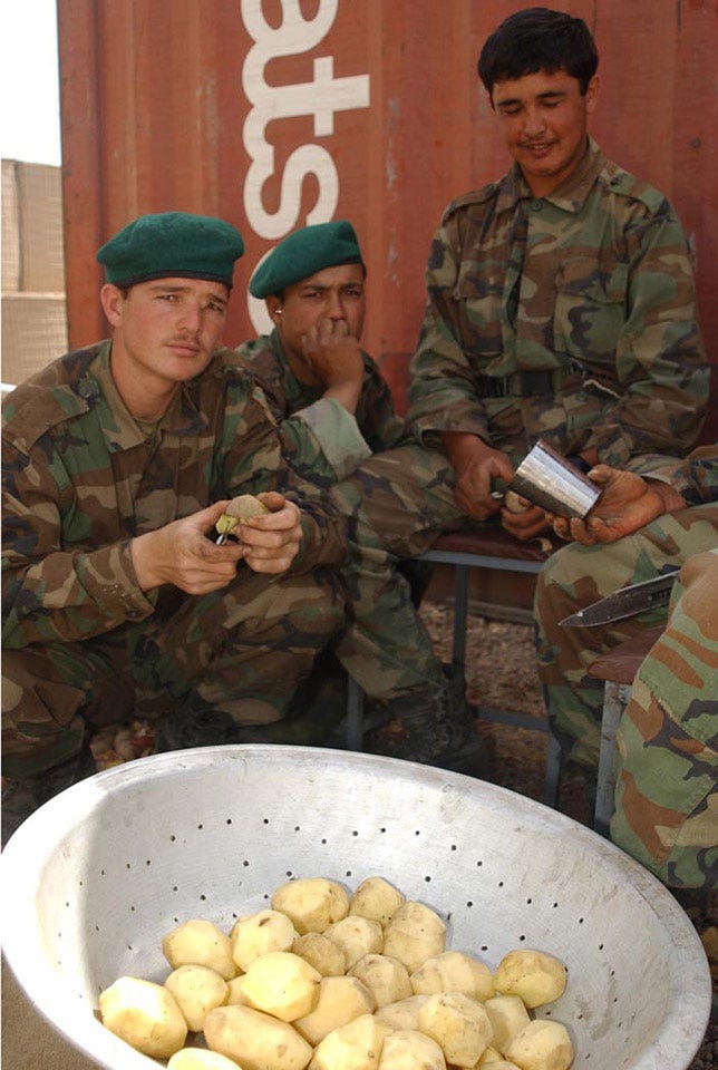Afghan National Army soldiers peeling potatoes at Camp Tombstone, 2006 ...
