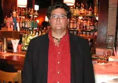 Photo of a man standing in front of a bar