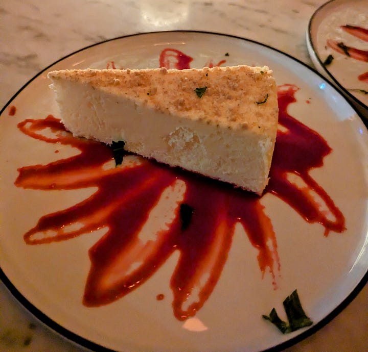 Left to right: Creme brûlée cheesecake over a splattering of raspberry sauce; chocolate ganache cake with whipped cream over raspberry sauce 