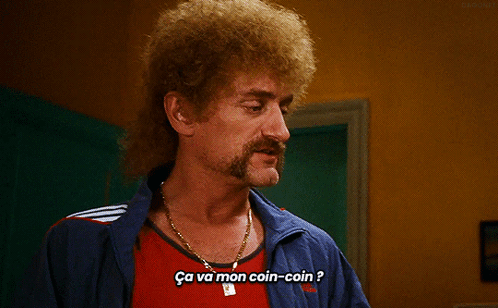 a man with a mullet and a mustache says ca va mon coin coin