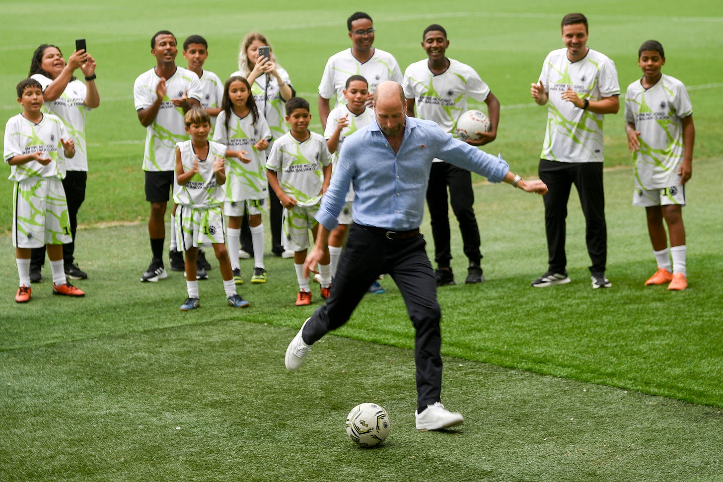 Prince William kicking a football Prince William kicking a football