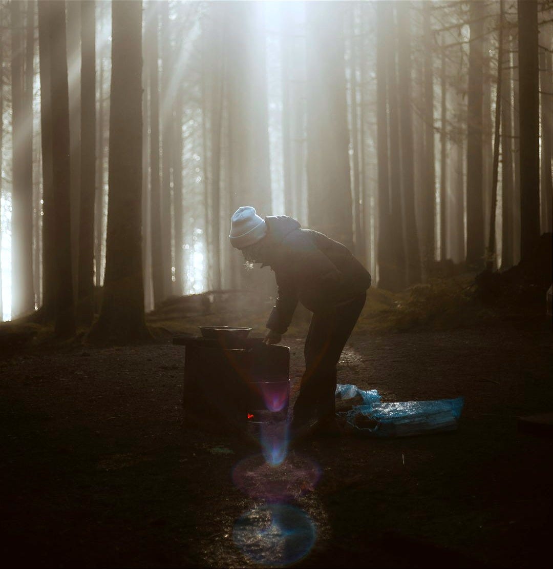 a man standing in the middle of a forest a man standing in the middle of a forest