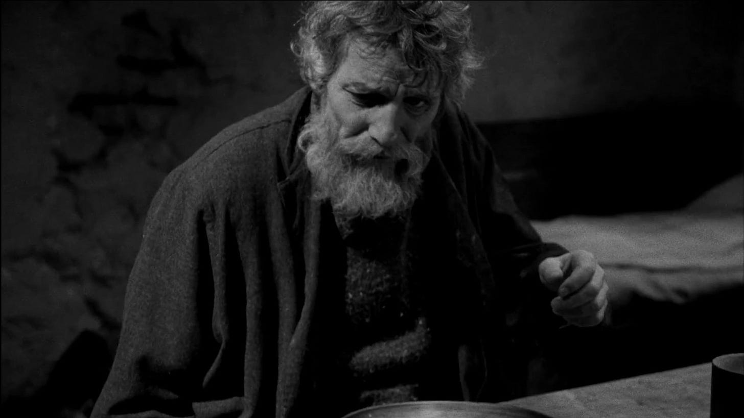 The Turin Horse | Still features a bearded farmer surrounded by a derelict home. The Turin Horse | Still features a bearded farmer surrounded by a derelict home.