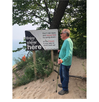 A person standing next to a sign

AI-generated content may be incorrect.