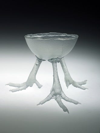 A glass bowl with feet

AI-generated content may be incorrect.