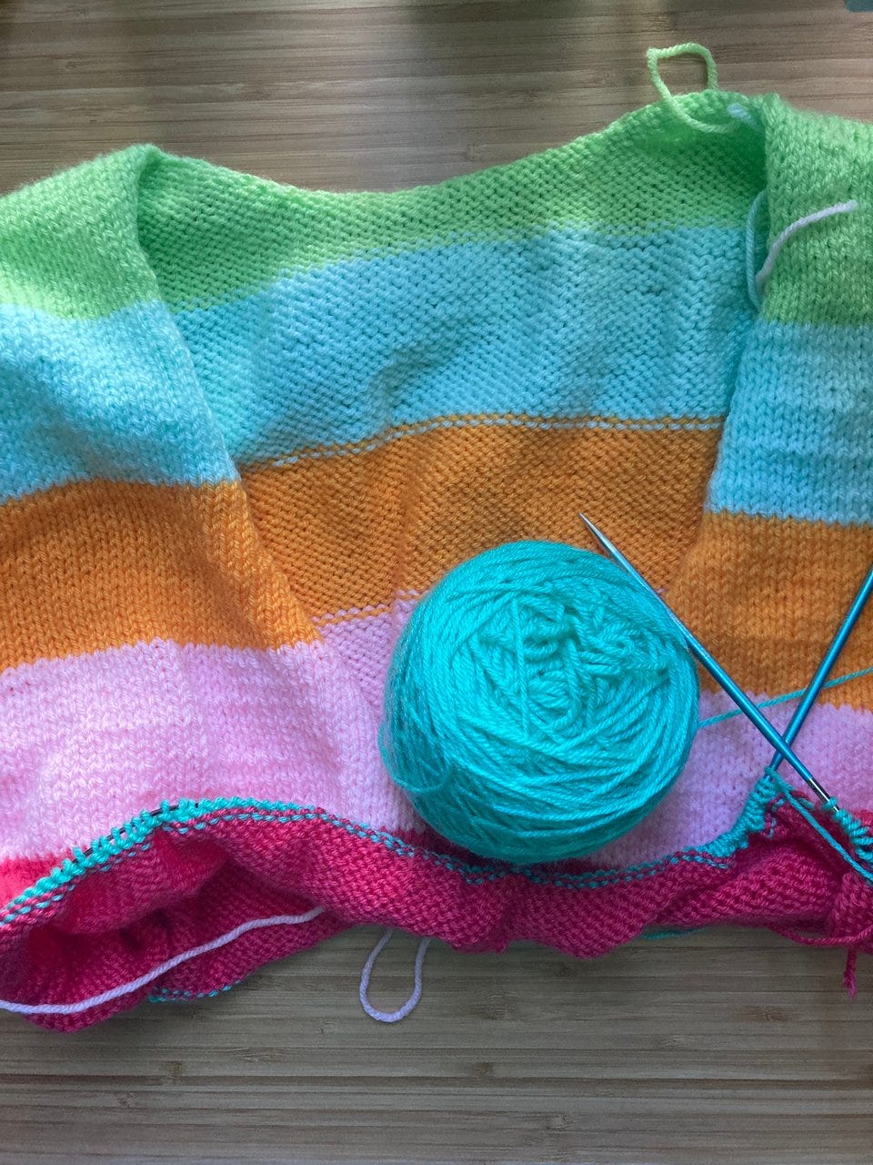 a knitted sweater with yarn and knitting needles