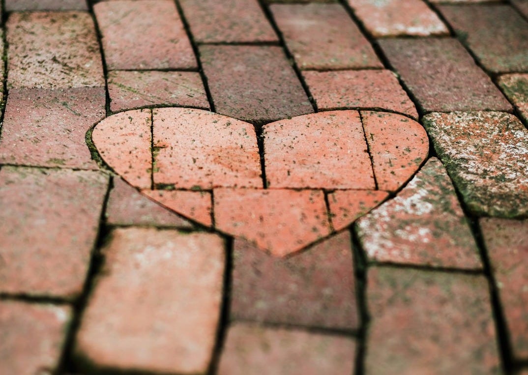 A brick pathway with a heart-shaped inlay