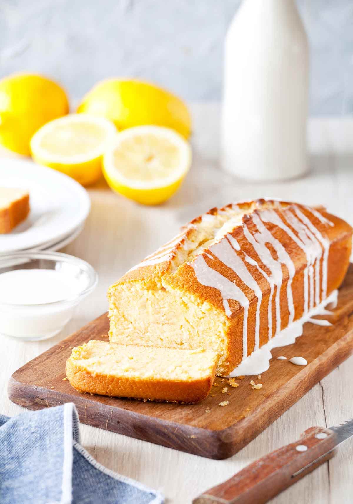 A classic, buttery Ina Garten’s Lemon Cake glazed with a translucent lemon-sugar syrup and thick white confectioners’ sugar icing.